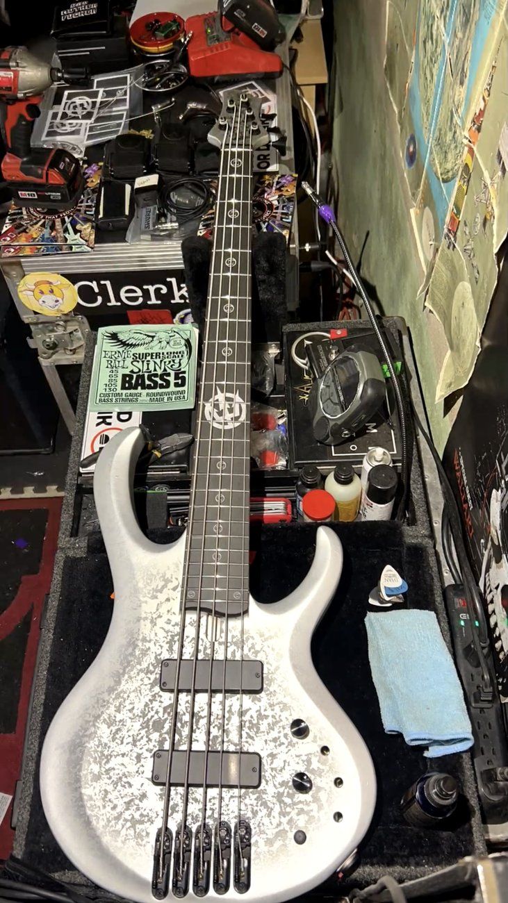 The silver Ibanez BTB five-string on the workbench with a fresh set of Ernie Ball Bass 5 strings