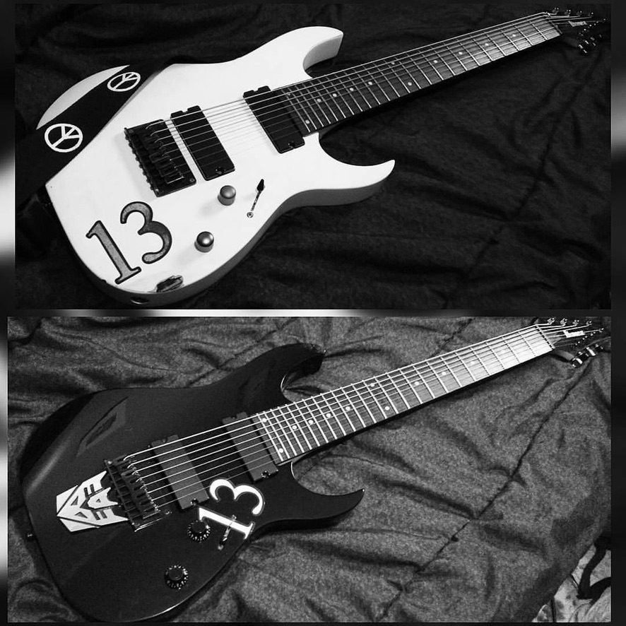 Matching white and black number 13 eight-string guitars