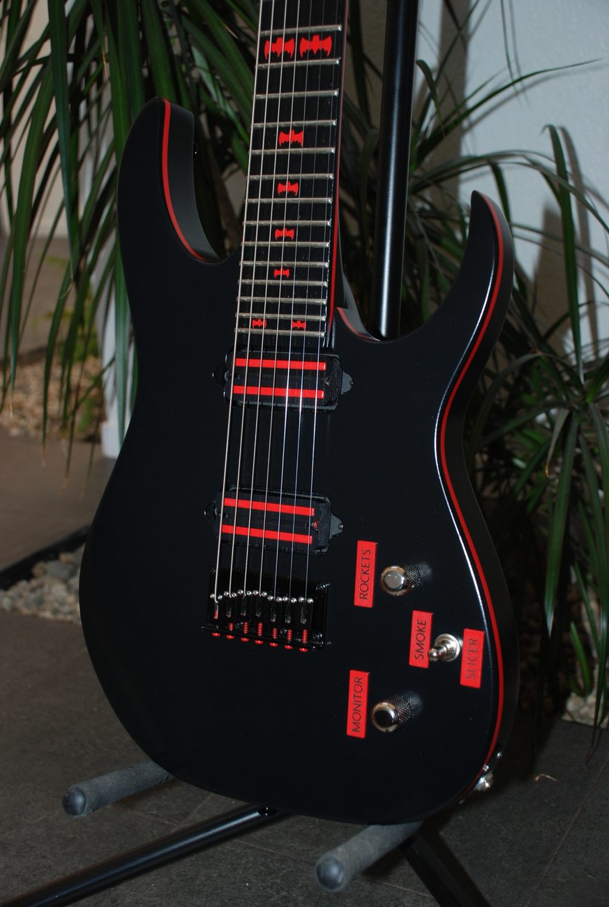 The 1966 Batmobile: black seven-string with red pinstripe, bat inlays and switches labeled Monitor, Rockets, Smoke and Slicer