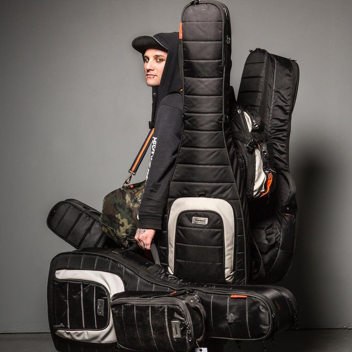 Dean with his full set of MONO cases: dual bass and dual guitar bags, backpacks and a camo gig bag
