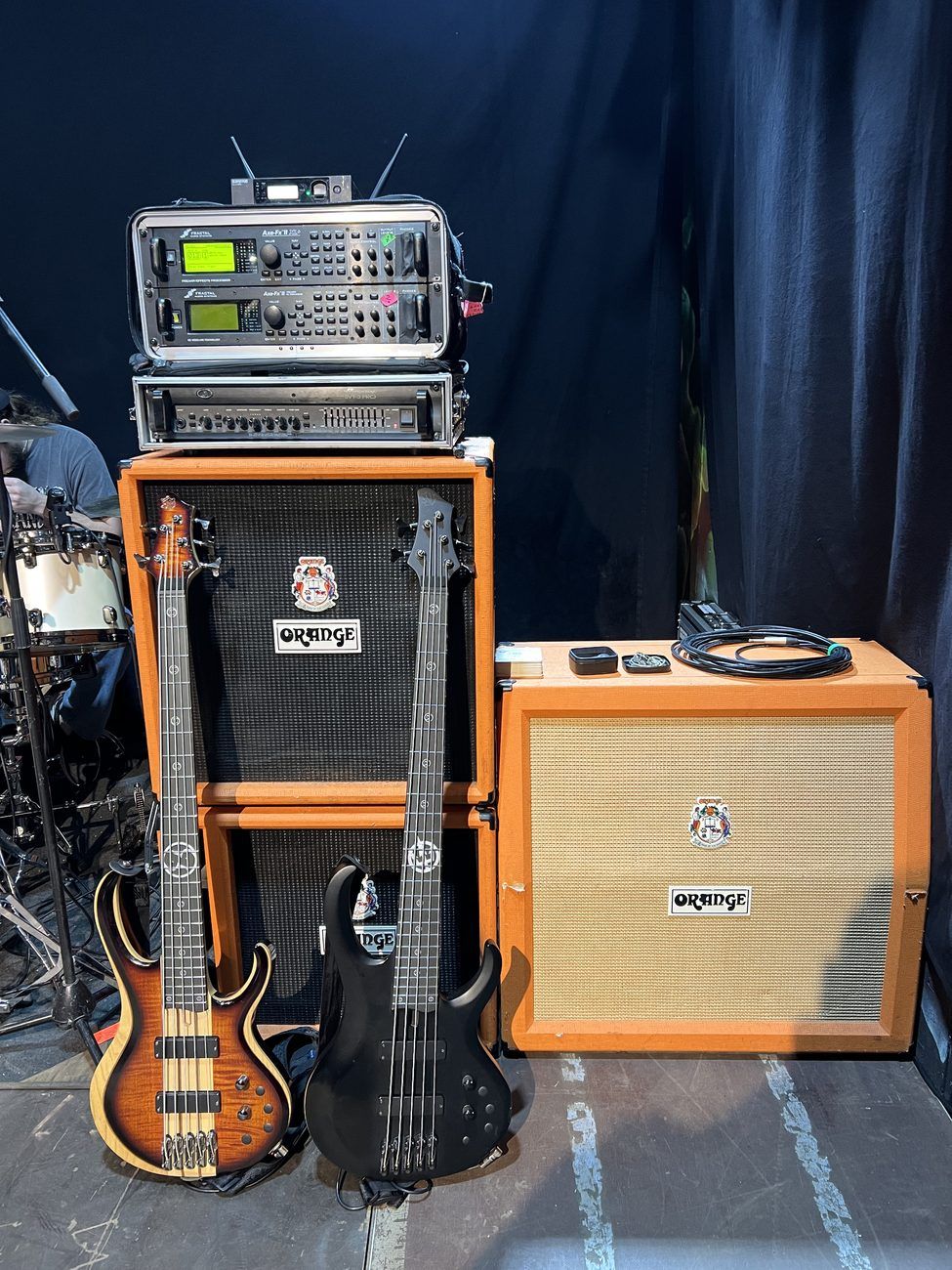 Touring bass rig with stacked Orange cabs and two BTB five-strings